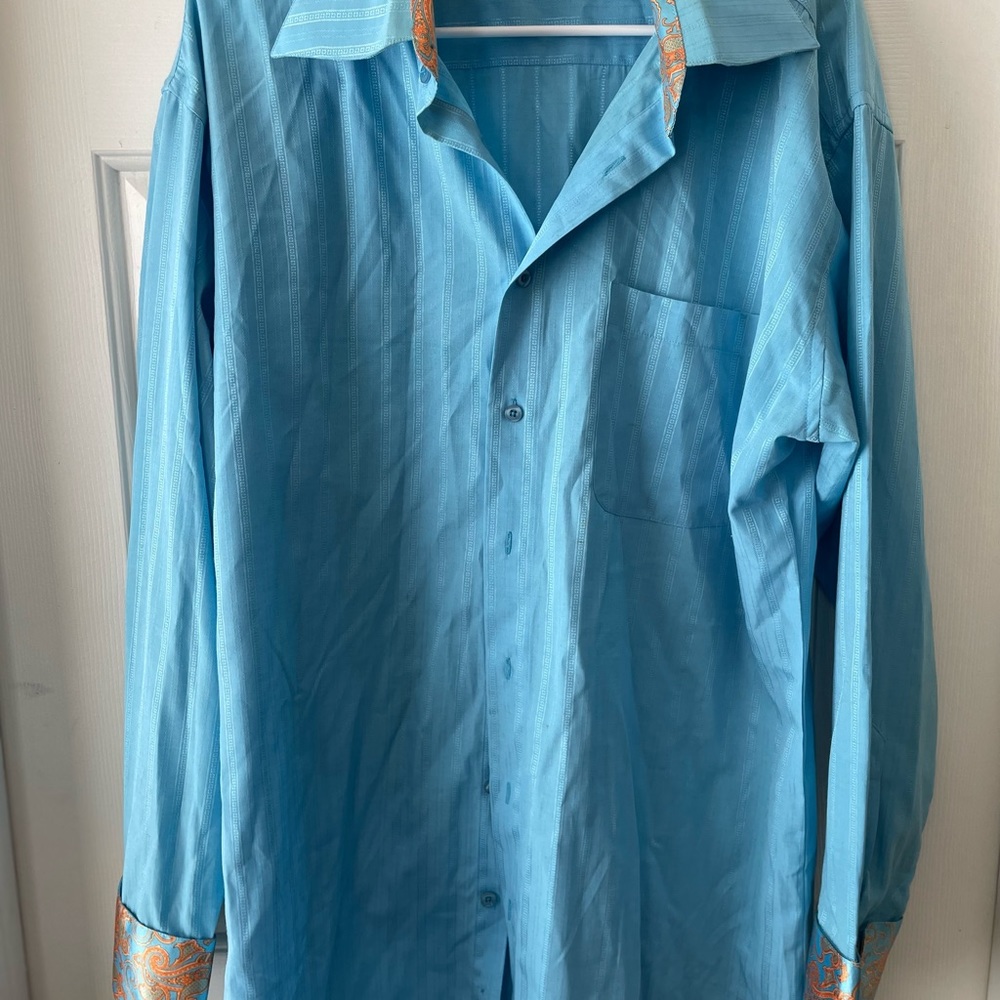 Long sleeve baby blue with orange scroll design on hand cuffs